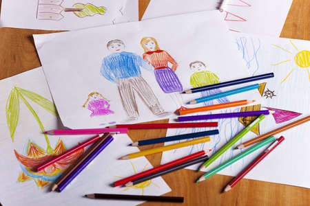 children s drawings and color pencils on the tableの写真素材