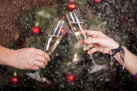 Christmas New Year's toast on the background of the Christmas tree in snowの写真素材