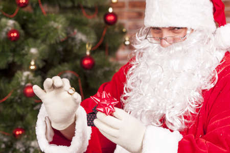 Jewelry ring gift Santa Claus under the Christmas treeの写真素材
