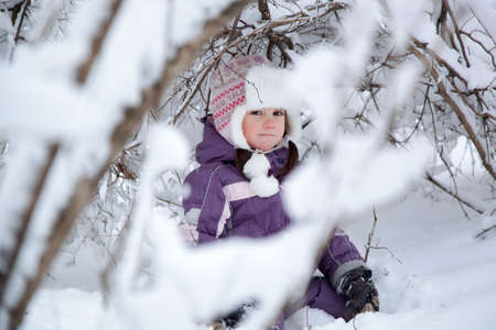 wonderful girl child in the snowy woodsの写真素材