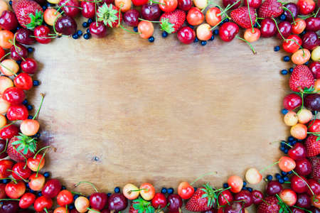 Frame from fruit for a card on the background of wooden boardsの写真素材