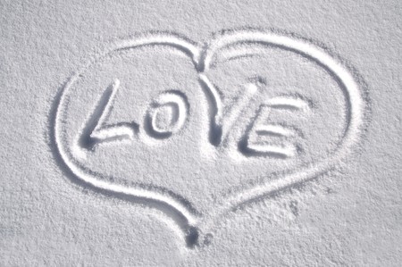 Heart drawn on the snow with title LOVEの写真素材
