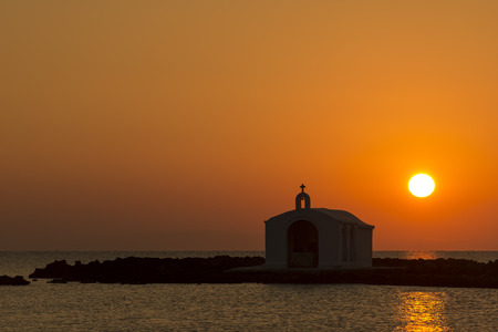 Catholic Church As Silhouette Against The Sunrise In Georgioupolis, Crete, Greeceの写真素材