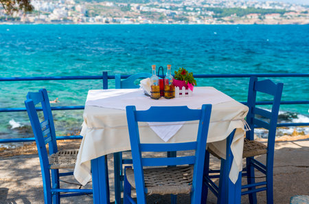 Table And Chairs In A Typical Tavern By The Sea At Rethymnon, Crete, Greeceの写真素材