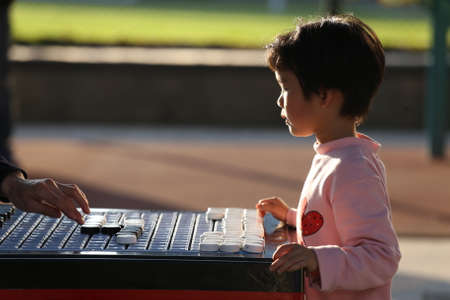 little kid playing board gameのeditorial素材