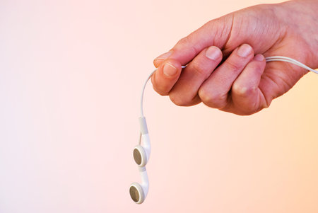 Headphones held in his handの写真素材