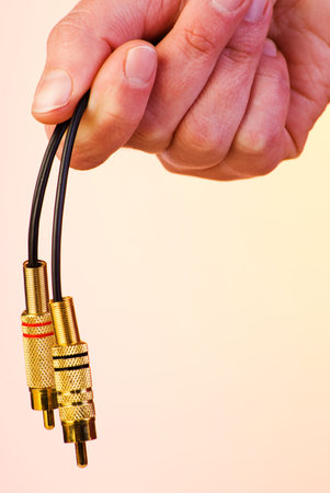 Audio connectors held in his hand