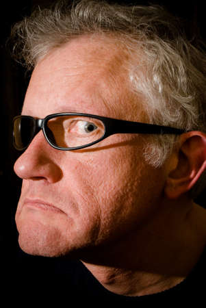 Portrait of a man with sunglasses, with one glass missingの写真素材