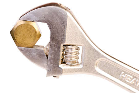 Adjustable wrench with nut isolated on whiteの写真素材