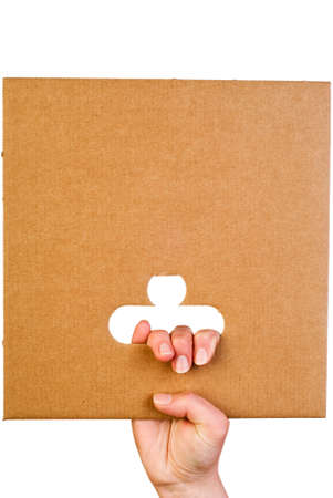Sheet of corrugated cardboard in hand isolated on whiteの写真素材