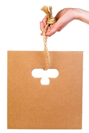 Sheet of corrugated cardboard hanging on rope isolated on whiteの写真素材