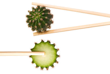Cactus and sliced cactus in chopsticks isolated on white backgroundの写真素材