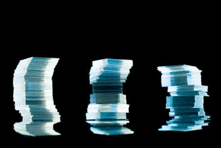 Stacks from very thin glass on reflective surfaceの写真素材