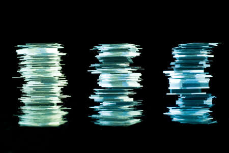 Thin glass stacks on reflective surfaceの写真素材