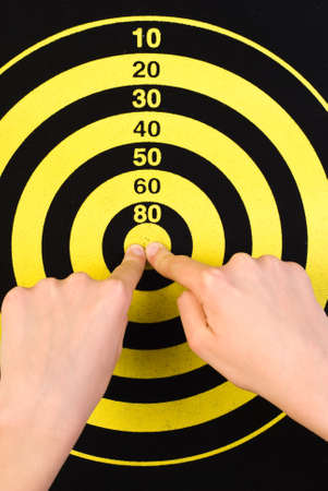 Fingers are shown in the center of targetの写真素材