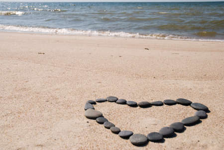 Heart made from stone chips on the beachの写真素材