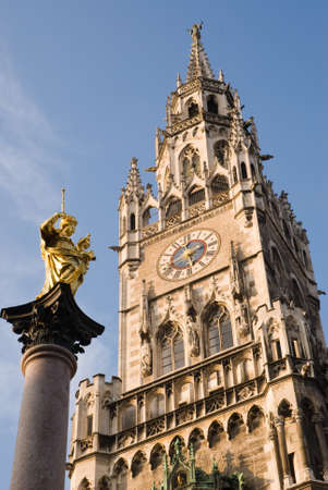 The statue of Maria and the Munich mediaval town hall.の写真素材