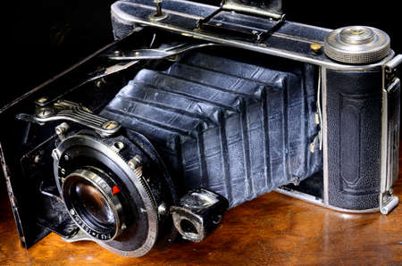 Close up of antique bellows camera on mahogany tableの写真素材