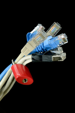 Internet cables with a lock on its against black background