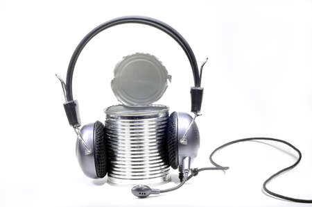 Headphones with microphone worn by opened can on white backgroundの写真素材
