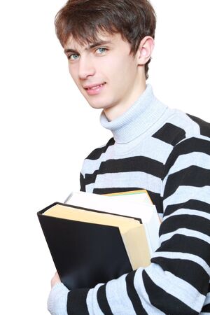 Young guy with books in hands on white background.の写真素材
