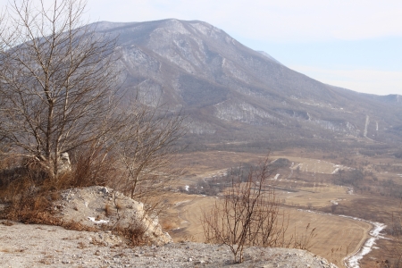 View from mountain top on a valley and a big hillの写真素材