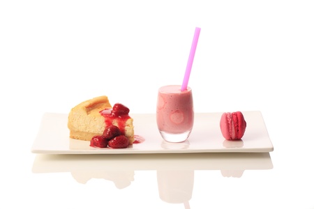 Strawberry smoothie with cake and macaroon. Isolated on white backgroundの写真素材
