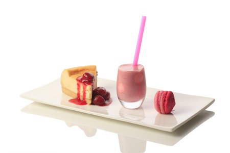 Strawberry smoothie with cake and macaroon. Isolated on white backgroundの写真素材