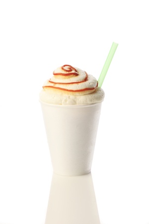 Cold milk shake with caramel in a foam cup. Isolated on white background.の写真素材