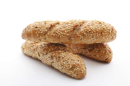 Homemade brown bread with cereals on white backgroundの写真素材