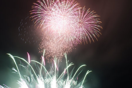 Colorful fireworks of various colors over night sky, celebration and anniversary conceptの写真素材