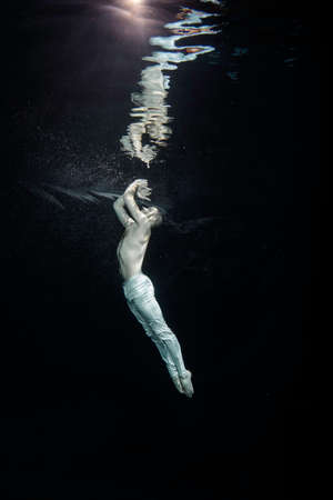 Young male ballet dancer unerwater