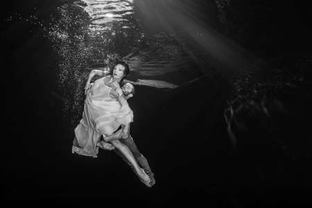ballet dancers of young couple dancing underwaterの写真素材