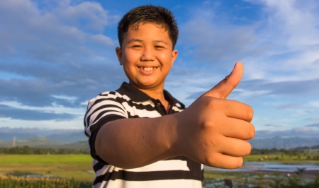 Smiling kid with thumbs up gestureの写真素材