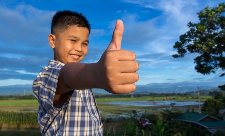 Smiling kid with approval hand gestureの写真素材