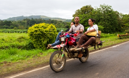 Bukidnon, Philippines - November 26, 2012: A driver and his passengers in a unique public  transport in the country where a motorcycle is modified to carry more than three people called Habal-Habal or Skylab. のeditorial素材