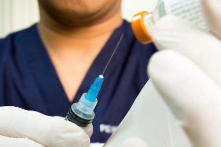 Doctor withdrawing medication の写真素材