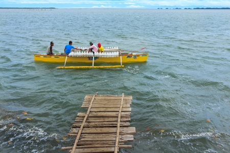 June 30, 2013- Pangasinan Province, Philippines  Small wooden boat called Bangka is used to transport potable water to nearby islands in the province のeditorial素材