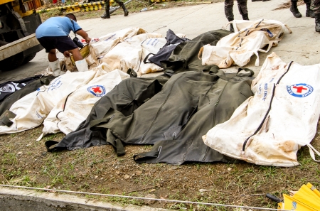 Tacloban City, Leyte - November 16, 2013  A total of 393 cadavers, in black bags, were laid in a mass grave nearby a public cemetery in the northern part of the city in the aftermath of typhoon Haiyan  Only 10-15 percent of the bodies were identified のeditorial素材