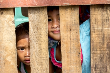 Tacloban City, Philippines- January 8, 2014   A January 5, 2014 photo shows survivors of Typhoon Haiyan shyly peep from their temporary shelter, their house was damaged by Typhoon Haiyan  local name Yolanda  that struck central Philippines last November 8のeditorial素材