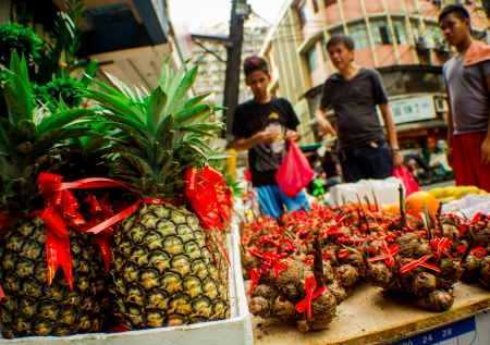 Metro Manila, Philippines-January 25, 2014: Street vendor selling assorted fruits for good luck. A week before the annual celebration the Filipino-Chinese community prepares to welcome the Lunar New Year in Manila's Chinatown district, Binondo. Chinatown のeditorial素材