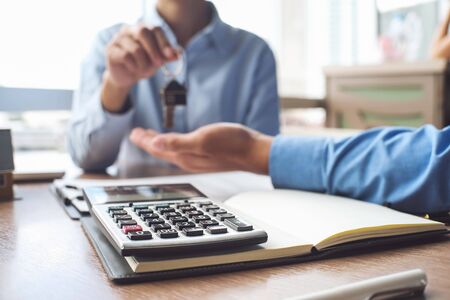 Calculator and business Insurance authorities showing an insurance policy and dealing the policyholder must to signの写真素材