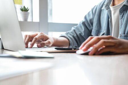 Close up of man hands working with laptop at office. Business concept