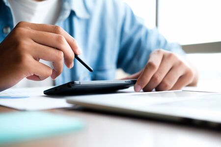 Business man using smart phone and laptop to work at office. Business and technology concept