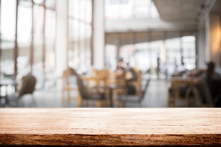 Desk space and blurry background of cafe coffee shop for product display montageの写真素材