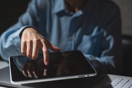 Business woman hand pointing at empty white screen tabletの写真素材
