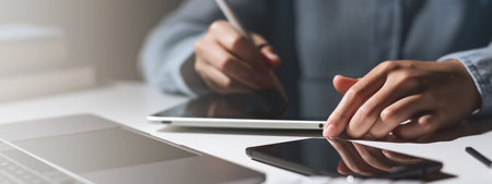 Hands of student using tablet and electronic pen. education e-learning concept for bannerの写真素材