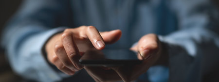 Close up of business man hands using smart phone vintage tone. Business technology concept for bannerの写真素材