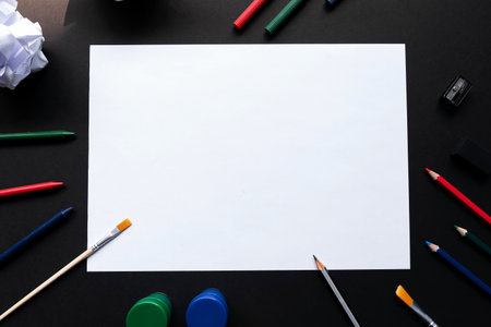 Top view of empty white sheet of paper with painting tools or drawing toolsの写真素材