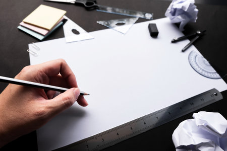 Man hands working with tools sketching on empty white paperの写真素材